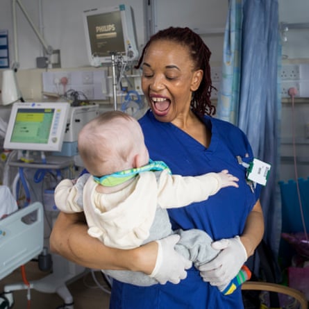 Paediatric nurse Patience Makuyana holds Marciee’s brother Freddie