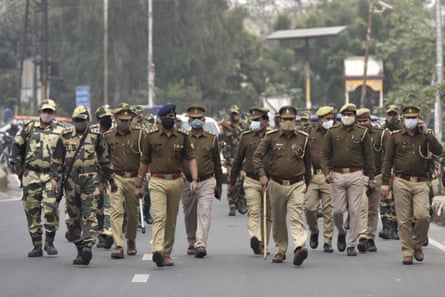 Police and border guards in camouflage march along a street in uniform