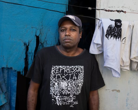 Cilirio stands outside his home wearing a baseball cap and T-shirt.