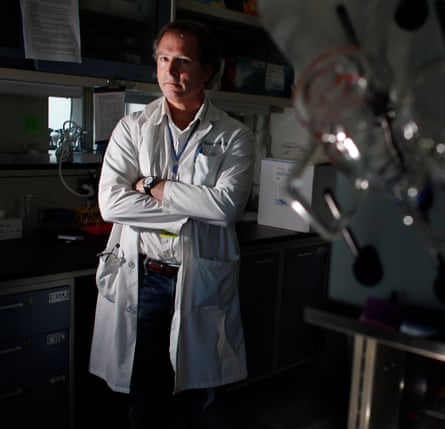 David Relman poses in a white lab coat