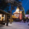 Tourists walk around Santa Claus Village in the dark