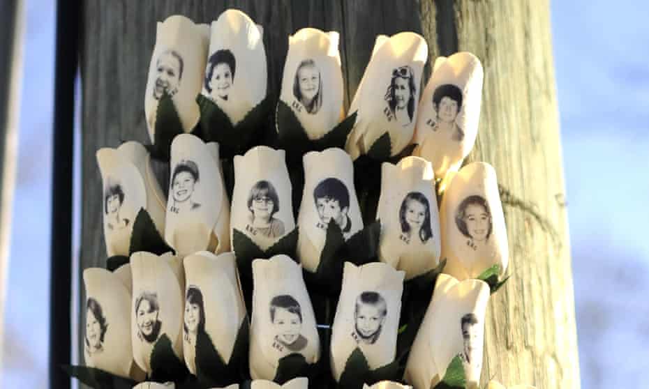 Roses with the faces of the Sandy Hook students and adults killed are seen on a pole in Newtown, Connecticut.