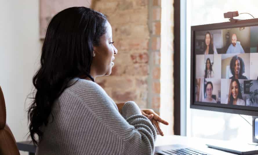 Working from home, woman meets with colleagues via video conference
