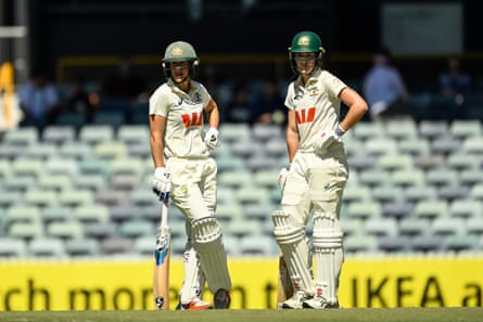 Ellyse Perry and Annabel Sutherland take a break during day two of the Test against India in Perth.