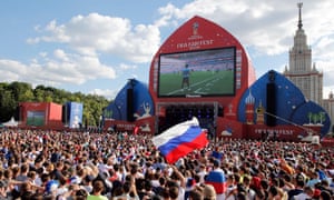 Fans watch the match between Uruguay and Russia on a big screen in Moscow