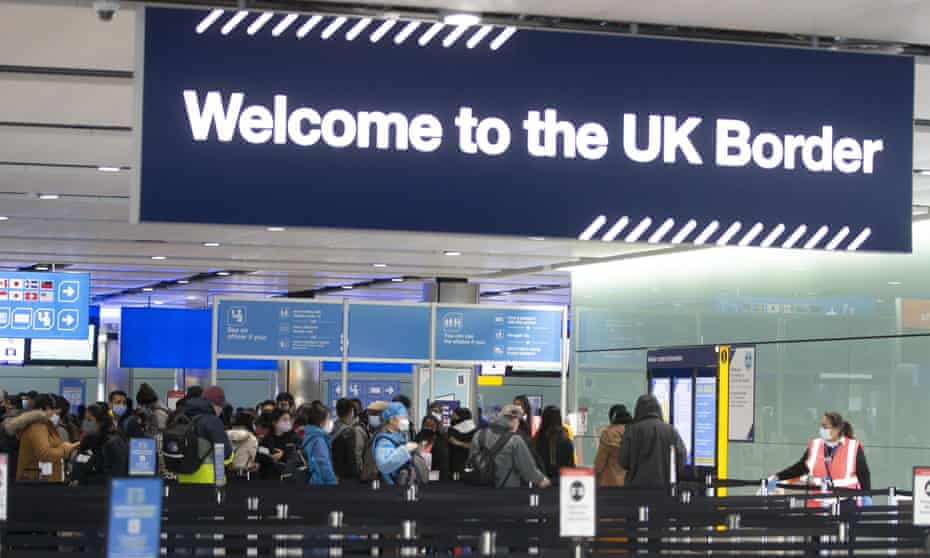 Passengers line up for passport control at Heathrow airport in London.