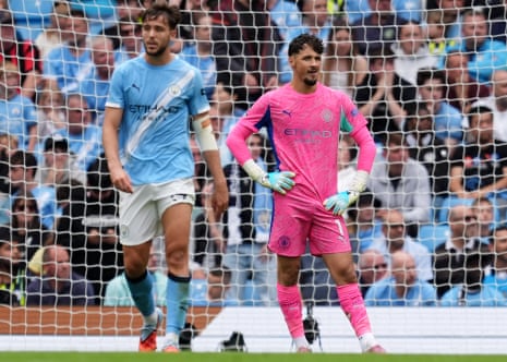 Manchester City goalkeeper James Trafford looks dejected after conceding their second goal.