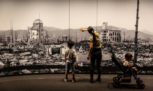 Visitors at Hiroshima Peace Memorial Museum view a large scale panoramic photograph of the aftermath of the atomic bomb attack on Hiroshima