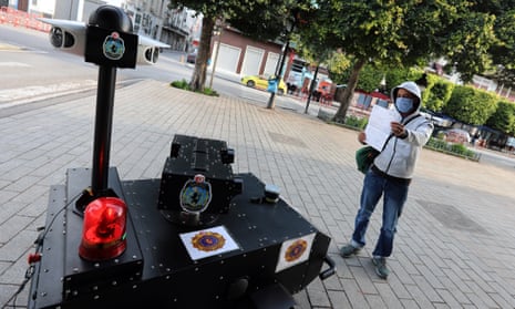 A police robot in Tunis checks the exit permit of a citizen while calling residents to respect a quarantine order.