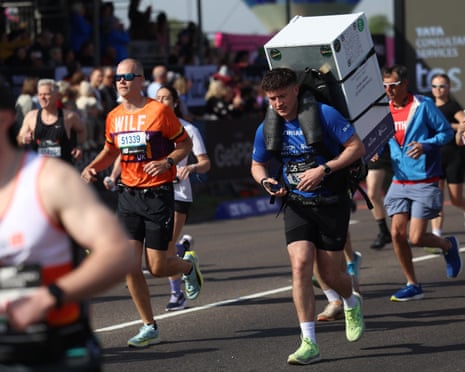 A runner carrying a fridge starts the London Marathon.