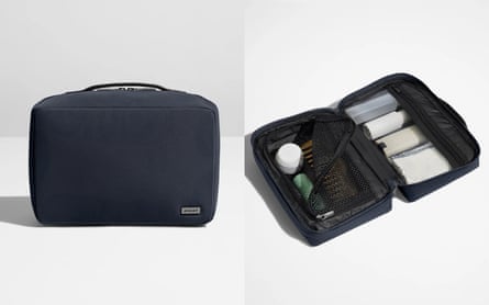 The Away toiletry bag is pictured in its closed form and opened up. The bag is navy blue