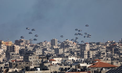 Humanitarian aid packages are dropped from a plane over Gaza City.