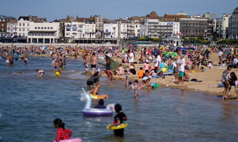People on the beach in Margate, Kent, in hot weather, June 2020. 