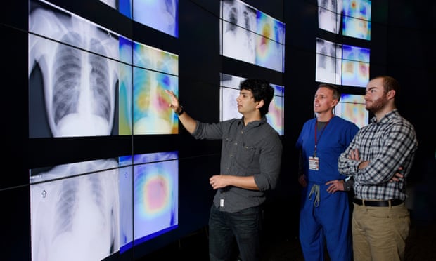 Graduate students Pranav Rajpurkar, left, and Jeremy Irvin, right, meet with radiologist Matt Lungren, MD, to discuss the results of tests using the algorithm the students developed.