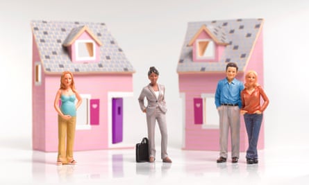 Four cake topper figurines: one of a pregnant woman, one of a woman in a suit with a briefcase, and one of a couple standing in front of a pink house.