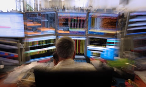 A trader watching screens at an office of the French investment company Aurel BGC.