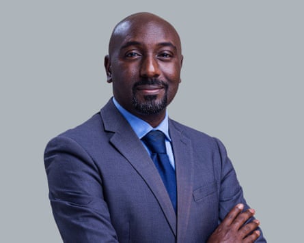 Portrait of Kijanangoma in suit smiling at camera