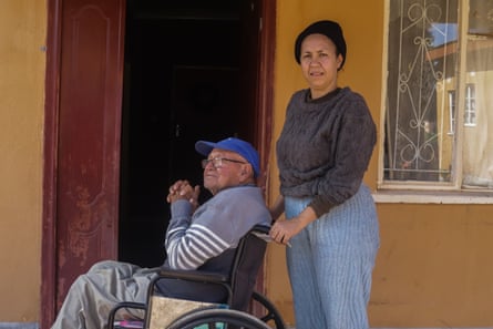 Kelly Jansen stands next to her father in his wheelchair