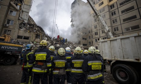 Firefighters conduct search and rescue operation in the rubbles of destroyed residential building in Dnipro