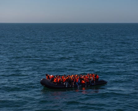 Migrants cross the Channel in a small inflatable boat