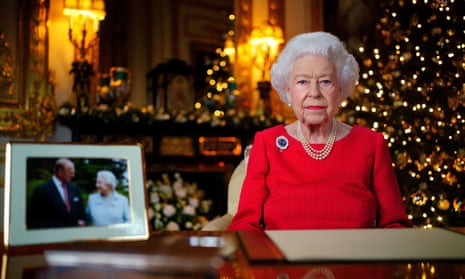 Queen Elizabeth II delivers her speech next to a photograph of herself with the Duke of Edinburgh.