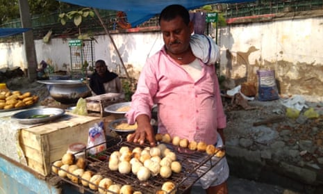 A street vendor in Patna prepares litti chokha, stuffed wheat flour balls.