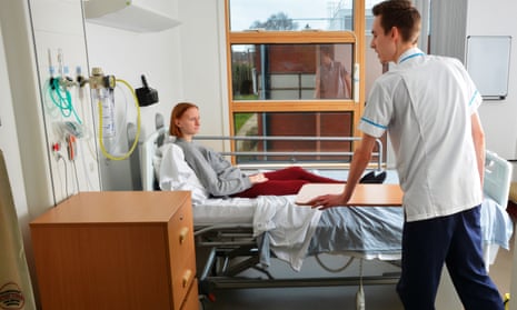 Nursing student Ben Craig, 24, attends to a Kettering patient, Kirsty Williams