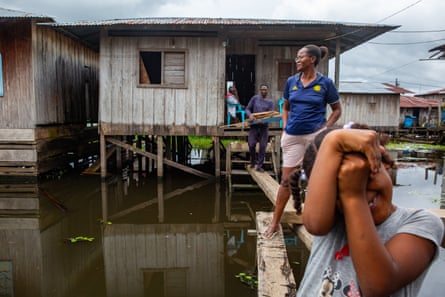 Evangelina Murillo, a worker of the Association of Community Councils and Ethnic-Territorial Organisations of the Lower Atrato, stands on the wooden board in her neighbourhood