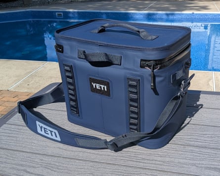 A Yeti Hopper Flip 18 cooler sitting on table beside pool outside