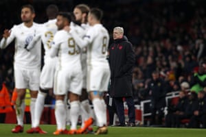 Arsene Wenger looks bemused as Ostersunds’ players celebrate.
