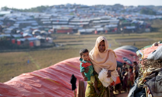 A Rohingya woman and child walk through the Jamtoli refugee camp in Bangladesh. More than 640,000 Rohingya people have fled Myanmar.