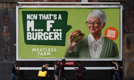 Advert of a woman holding a burger, strapline says: "Now that's M*** F*** burger"