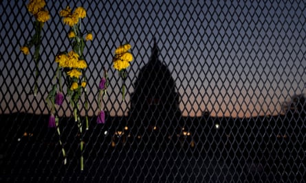The silhouette of the US Capitol behind a security fence in Washington, DC, in April.