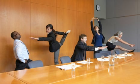 Executives stretching in a conference room