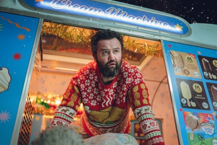 He leans out of an ice cream van in Christmas jumper