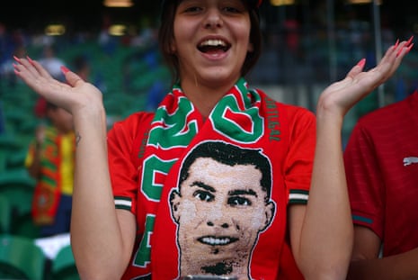 A Portugal fan with a scarf featuring Cristiano Ronaldo.