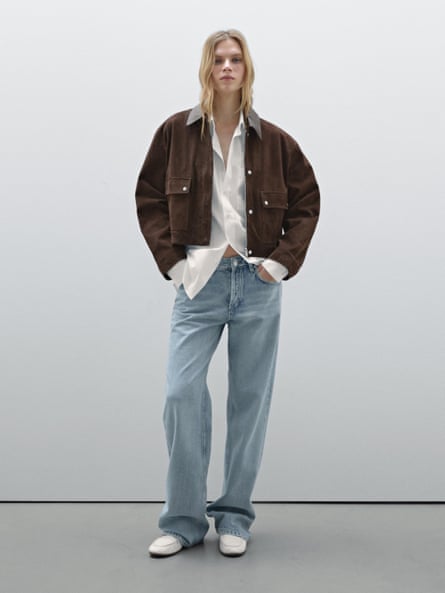 Model wearing tan oversized suede jacket, white shirt and pale blue jeans