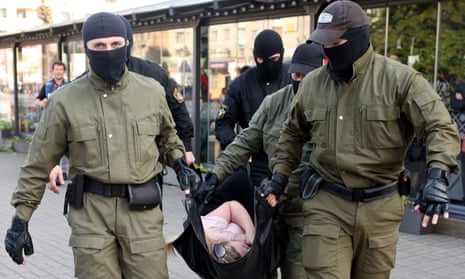 Officers carry a woman away during a protest in Minsk on 19 September.