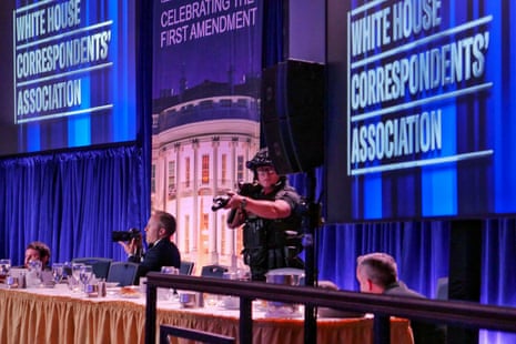 Getty Images photographer Andrew Harnik takes photos as agent points his weapon after an incident at the annual White House Correspondents Association Dinner April 25, 2026 in Washington, DC.