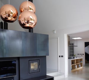 Tom Dixon lights above a custom-built wood-burner.