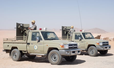 Two armed military vehicles in the desert in Saudi Arabia