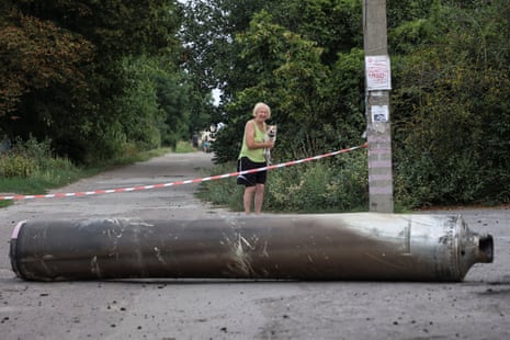 A woman looks at a part of a missile after a Russian military strike in Kramatorsk, Donetsk.