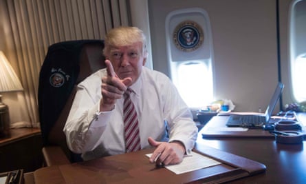 TOPSHOT - US President Donald Trump poses in his office aboard Air Force One at Andrews Air Force Base in Maryland after he returned from Philadelphia on January 26, 2017. Donald Trump made his maiden voyage outside the Washington area as US president Thursday, meeting with lawmakers to map out their 2017 policy strategy and smooth emerging differences between the White House and congressional Republicans. / AFP PHOTO / NICHOLAS KAMMNICHOLAS KAMM/AFP/Getty Images
