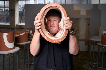 Vegas looks through his ceramic sculpture.