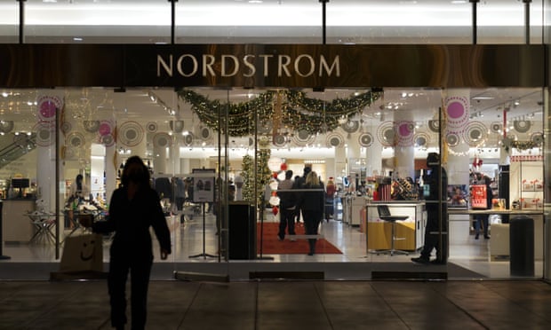 A security guard stands at the entrance to a Nordstrom department store at the Grove mall in Los Angeles, where a smash-and-grab robbery took place in December. 