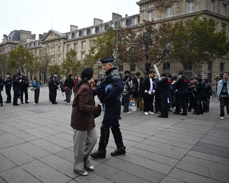Police officers checking protesters and their belongings