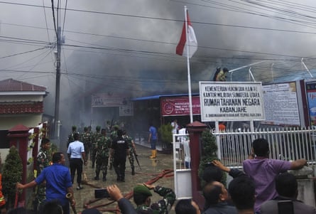 Smoke billows from Kabanjahe prison, North Sumatra, during a riot on 12 February.