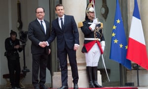 Emmanuel Macron is welcomed by his predecessor François Hollande as he arrives at the Élysée Palace in Paris