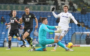 Nick Pope of Burnley tackles Patrick Bamford of Leeds United leading to a penalty.
