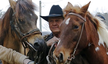 Roy Moore walks his horses after voting.
